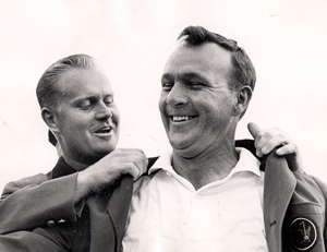 Arnold Palmer receiving his final green jacket from Jack Nicklaus in 1964. (Photo by augusta.com)